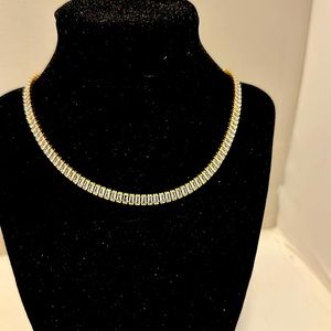 Beautiful gold and clear stone necklace. It says waterproof and tarnish proof